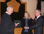Legislator Mark Fruce recites the oath of office for the District 24 seat on the County Legislature. Holding the Bible is his wife Beth. Hon. Norman Seiter Jr., State Supreme Court Justice, swore in new legislators at the 2010 organizational meeting. Legislator Fruce represents portions of Fulton and Granby.
