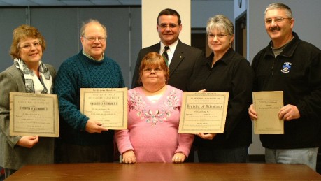 Uncovered Century-Old Records Town officials hold 100-year-old documents which provided a list of attendance in local one-room schools. From left are Town of Oswego Supervisor Victoria Mullen, Oswego Town Historian George DeMass, Oswego School District Records Clerk Liz Woods, Superintendent of Schools Bill Crist, Minetto Town Historian Kathy Mulcahey and Town of Minetto Supervisor Joe Hawksby.
