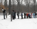 HOLLIS snow shoe in the woods Jim Farfaglia, camp director, points out some interesting nature facts as he leads a group of snowshoers through the woods near camp.