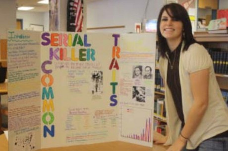 Senior Jessica Palmitesso displays her Criminal Justice class project on the common traits of serial killers during a recent exhibit. Students in Mr. Patnode's class presented their findings over a two day period in late January. (Sarese Gibson photo)