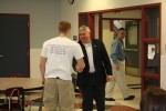 Zach Welling of SOS greets State Senator Darrel Aubertine.