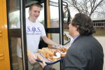 DiFabio delivers to Welling a tray of donuts and pastries sent by Sandy Creek Superintendent Stewart Amell as students board the bus for home.