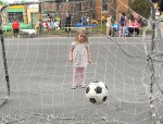 healthy kids soccer Kailynn Milseki watches as the soccer ball she kicked rolls into the net for a goal.