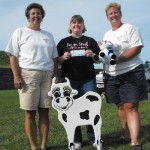 COW winner Cow Chip Bingo winner Sheena Gates, center, receives her winnings from Oswego Lions member Karen Hammond, right. At left is Oswego Lions member Beverly Spuhler.