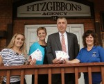 FitzGibbons Agency Assists Buc Booster John and Tara FitzGibbons of the FitzGibbons Agency presented the schedules to OHS basketball and lacrosse player Taylor Giglio and Buc Booster Board member Lisa Giglio.