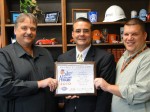 School Safety Excellence Oswego Superintendent of Schools Bill Crist proudly displays the School Safety Excellence Award plaque as he is joined by Superintendent of Buildings and Grounds Dave Crisafulli and Transportation Director Tom Gunn.