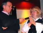 trinity spelling and a prayer Betsy Copps spells a word as Dan Cummings holds the microphone for her.