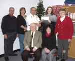 Realtor_Donation Bill Galloway of Century 21 Galloway Realty, president of the Oswego County Board of Realtors, presents Karen Merrill, program coordinator, with a donation in support of OCO’s PATH program. Seated from left are: Gene Friske, executive Officer of the Oswego County Board of Realtors and Marilyn Boyzuick of Century 21 Galloway Realty. Standing from left are: Derek Woodmancy of Realty USA, Patti Murray of Century 21 Galloway Realty, Galloway, Merrill and Flo Farley of Janice Snyder Realty.