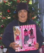 SBS_Toy_Donation Lynda, a member of the Step By Step Clubhouse, displays one of the many toys that members donated for the Let’s Give a Kid program.
