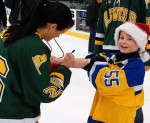 SUNY_Holiday_Skate_2 Megan Howe of the SUNY Oswego Lakers Women’s Ice Hockey team signs an autograph for a happy fan at the third annual SUNY Oswego Holiday Skate.
