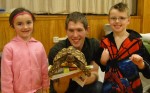 Turtles, Alligators & Lizards Excite Kindergartners Tequila Smith and Devan Bryan joined with Oostdyk as he holds one of the stars of the show… his pet tortoise.