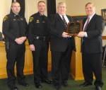 sheriff recognized Peter Kehoe, right,executive director of the NYS Sheriffs' Association, presents a plaque to Oswego County Sheriff Reuel Todd in recognition of the Civil Division gaining accreditation. Joining them are Undersheriff Robert Lighthall and Deputy Cory E. Monroe, left.