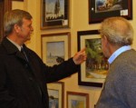 ART open_house_arts_mayor Oswego Mayor Randy Bateman, left, discusses a piece of artwork with Allen Bjorkman, of Lakeside Artisans’ Cooperative, during the open house at the co-op Tuesday night. (Photo provided by Beth Clark)