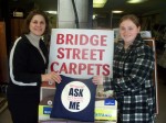 CR_Month_BSC_Pulaski Peggy Francher, owner of Bridget Street Carpets in Pulaski and Katie Batchelor, assistant with OCO’s Cancer Services Program, display the items OCO has provided merchants along Jefferson Street to distribute to their customers.