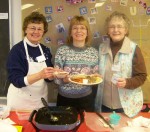 OCO Nutrition Help Line OCO volunteers Sally Anderson (left) and Pat Thayer (right) assist Patti Williams, a registered dietitian with OCO, serve up a nutritious lunch at OCO’s Senior Dining and Activity Center in the Phoenix Congregational Church.