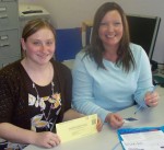 OCO offers Free Cancer Screening Kits Program Assistant, Katie Batchelor (left) and Coordinator of Oswego County Opportunities’ Cancer Services Program, Carolyn Handville, display one of the InSure Fecal Immunochemical Test kits for colorectal cancer that they are distributing in recognition of Colorectal Awareness Month.