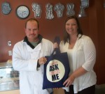 OCO_CR__Month_Edible_Construction_Pulaski Daniel Laveck, owner of Edible Construction Co. & Bakery in Pulaski, and Carolyn Handville, coordinator of OCO’s Cancer Services Program, display one of the items OCO has provided merchants along Jefferson Street to distribute to their customers as part of OCO’s “Main Streets Go Blue” campaign to raise awareness of colorectal cancer.
