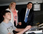 TVMobile_tour__ (5) Steve Coffey explains some of the equipment in the WBUC mobile studio to Assistant Superintendent for Curriculum and Instruction Cathy Chamberlain and Oswego High School Principal Brian Hartwell.