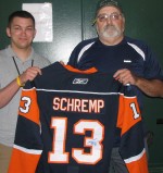 Autographed Rob Schremp Jersey Available Justin Sheppard of the Catholic Charities’ CYO program accepts an official New York Islander hockey jersey, autographed by local hockey hero, Rob Schremp, from Jerry Schremp (right).