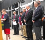 Leighton Poem Leighton student Eli Restuccia reads a poem honoring those who served and died protecting the flag. Looking on are members of the Oswego Battle of the Bulge organization. From right to left are: Bill Hogan, Mile Becker (partially blocked), Len Lambert, Len Maniccia, Phil Pecora and John Canale.