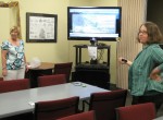 library demonstrating_how_it_works Theresa Slosek, left, and Lisa Czirr of the Public Computing Center at the Oswego Public Library demonstrate their new video conferencing equipment.