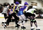 Oz Roller Girls Score Road Win Over Crown City The Oz Roller Girls' Mass Jennocide (right) tries to block Crown City Royal Pains skaters Evil Lucian (far left) and Criminal Miss Chief (145) to help teammate J Rock-It (second from left, in star helmet) get through during Oz's recent 172-109 win over Crown City.