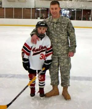 Noah Delaney and his dad in one of his favorite places - the ice hockey rink