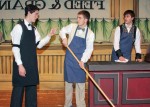 Horace Vandergelder threatens his employees Barnaby Tucker and Cornelius Hackl and forces them to get back to work at his hay and feed store in Yonkers, NY. Hackl and Tucker long for adventure, excitement and at least one night off from work a week. Unbeknownst to Vandergelder, the two plan to close the shop early and head to New York City. Pictured here are (l to r) Mitch Lalik as Horace Vandergelder, Logan Carvey as Barnaby Tucker and Brad Crofoot as Cornelius Hackl. The scene is from Jerry Herman and Michael Stewart's classic Broadway musical, Hello, Dolly! The production will be staged by Quirk's Players this Thursday, Friday and Saturday. Photo by Kelly LeVea