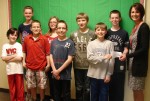American Red Cross Oswego Branch Director Danielle Hayden receives a donation from a few of the many fifth grade students at Kingsford Park School who participated in a Spell-A-Thon to raise money for the devastation following the earthquake and tsunami in Japan.