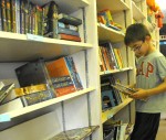 bookmobile reading Zachary DeMott checks out one of the hundreds of book available aboard the bookmobile.
