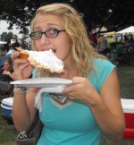 A young lady samples some of the summertime treats Harborfest is famous for.