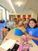 Participants at Kids at Cayuga summer camp take a lunch break. Approximately 40 youths participated in the weeklong camp and took courses that covered everything from computers to cooking to bug identification to Broadway-style dancing.