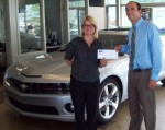 Rich Burritt of Burritt Motors in Oswego presents Executive Director of the United Way of Greater Oswego County, Melanie Trexler with a check in support of the agency’s annual Stuff-A-Bus Campaign. Held annually, the campaign collects school supplies for children in need throughout Oswego County.