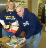 Director of Catholic Charities of Oswego County’s Emergency Services Program, Helen Hoefer and Ken Teramiggi, prepare a Food Sense package for pick-up.