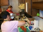 Instructor Kerrie Pratt (foreground) of Cornell Cooperative Extension demonstrates proper canning techniques to class participant AnnMarie Spicer.