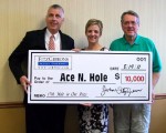Posing with the check, from left, are: John and Tara Fitzgibbons of the Fitzgibbons Agency and; Terry Hammill of the Oswego Opera Theater.