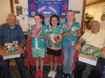Pictured are: World War II veteran resident Ralph Borek, Junior Girl Scouts Claudia, Willow-Su, and Desiree, and World War II veteran Fred Tesoriero.