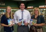 Nick Graham manager of Family Video in Fulton presents supervisor of Catholic Charities’ CYO Program, Stacie Roberts (left) and director of Catholic Charities’ Community Services Helen Hoefer with movies for the CYO teen lounge.