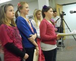 Claudia Chetney, at microphone, addresses the school board Tuesday night regarding the intramurals program. She is joined by, from left, Maddy Bullard, Abby Douglas and McKinley Thompson.