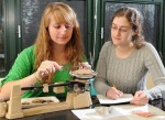 SUNY Oswego senior anthropology students Khrystyne Tschinkel, left, and Elisabeth Warszycki observe, research and catalog Native American pottery shards in a Mahar Hall lab, part of a project involving some 160,000 artifacts dating from prehistoric times to the 19th century.