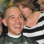 Jason Livesey of Rudy’s smiles after getting his head shaved in support of the fight against childhood cancer.