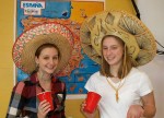 Hannibal High School students Adrienne Shortslef and Molly Downing enjoy Hispanic treats and drinks during World Languages Week.