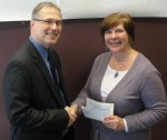 Diane Cooper-Currier (right), executive director of Oswego County Opportunities, receives a check for $1,000 from National Grid for a “Building Dreams” sponsorship presented by Walter Dengos, National Grid manager - community and customer management. National Grid is also entering a team in this year’s OCO Bowl O’Gold on March 10.