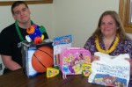 Pictured are program coordinator Marie Smith with Alex Familo as they sort through door prizes for the event.