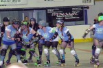 Oz Roller Girls blockers, from left, Gwynneth Pout'N'Throw, Medusa's Might, Lady RedKat and Ammie Oakley, clear a path for their jammer AJent Mayhem (far right) to get through during their recent 219-173 win over the Albany All-Stars A Team. (Connie Dickinson-Stauring photo)