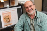 John Laundre of SUNY Oswego's biological sciences faculty shows the cover of his book, "Phantoms of the Prairie: The Return of Cougars to the Midwest," available at Internet booksellers and due soon to bookstores. The book foresees cougar populations returning to small areas in all Midwestern states -- and potentially, the East -- and documents where that has already occurred in South Dakota and Nebraska.