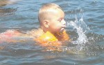 Three-year-old Tanner Shear enjoys a swim in Lake Ontario's cool water on Tuesday afternoon.