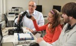 Dr. Rachid Manseur, director of the new electrical and computer engineering program at SUNY Oswego, works on programming a robotic arm with students Samantha Bielli and Ben Parsons. The bachelor's degree program will get under way for freshmen next fall.