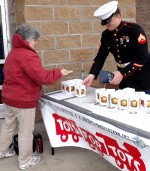 Ryan Candee accepts a donation toward the local Toys for Tots campaign